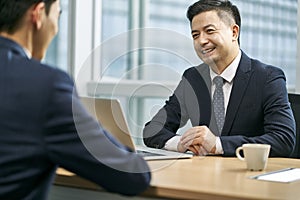 asian corporate executives discussing business in office