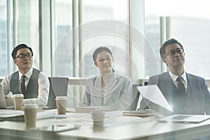 Asian corporate executives meeting in conference room