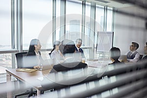 asian corporate executives meeting in conference room