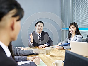 Asian corporate people discussing business in meeting