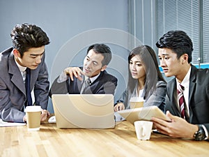Asian corporate people discussing business in meeting