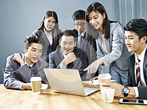 Asian corporate people reviewing business results