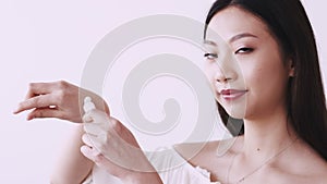 asian cosmetics skin care woman applying cream