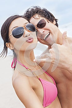 Asian Couple at Beach Taking Selfie Photograph