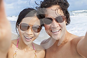 Asian Couple at Beach Taking Selfie Photograph