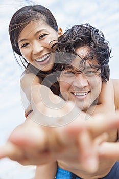 Asian Couple at Beach Taking Selfie Photograph