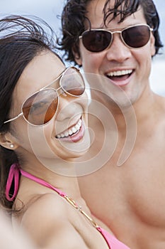 Asian Couple at Beach Taking Selfie Photograph