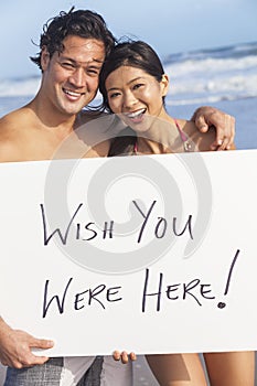 Asian Couple at Beach Wish You Were Here Sign photo
