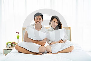 Asian couple in bedroom