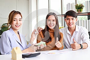 Asian couple buying a house with a real estate agent.