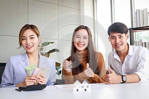 Asian couple buying a house with a real estate agent.