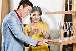 Asian couple buying stuff in furniture store