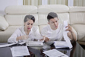 Asian couple checking their bills