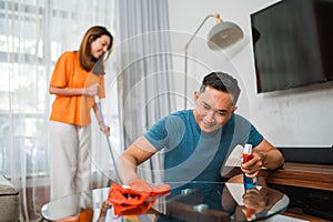 asian couple doing domestic chores together