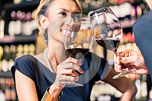 Asian couple drinking red wine