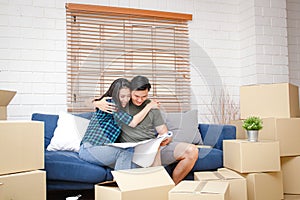 An Asian couple embracing each other rejoicing in building a new home.