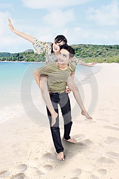 Asian couple enjoy honeymoon at beach