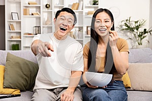 Asian Couple Enjoying a Movie Night Together at Home