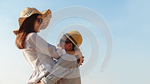 Asian couple expressing their feeling while standing at beach, Young couples hug on blue sky