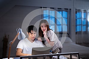 Asian couple freelancer boy and consultant girl manage money budget for business bill payment and calculate tax about advertising