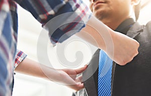 Asian couple getting dressed.