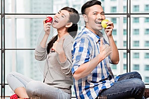 Asian couple having apples as healthy snack