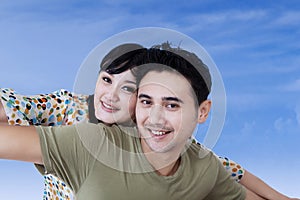 Asian couple having fun on blue sky