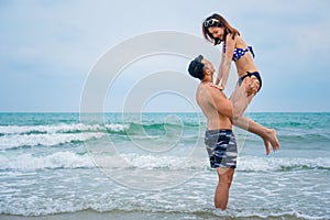 Couple having fun and ramance moment playing together on beach