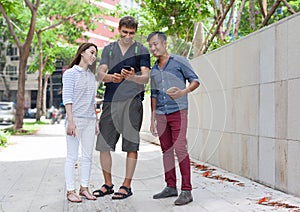 Asian couple help tourist cell smart phone