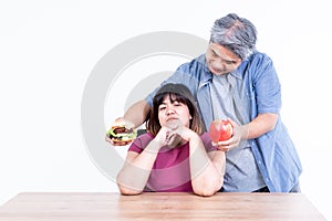 Asian couple, The husband delivered hamburgers and apple for his wife to choose from