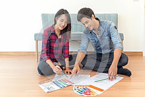 Asian couple just new married husband and his wife design and select color for new house
