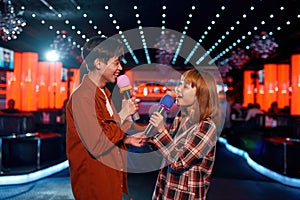 Asian couple in love singing song at karaoke party