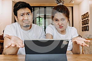 Asian couple lover in cafe get confused with application in the tablet computer