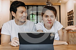 Asian couple lover in cafe get confused with application in the tablet computer