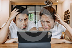 Asian couple lover in cafe get confused with application in the tablet computer