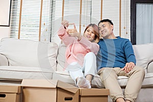 Asian couple planning to decorate house after moving to new home
