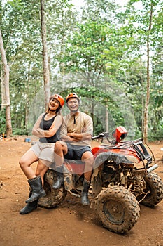 asian couple pose with handcrossed while taking a picture