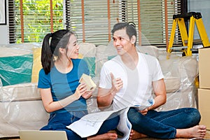 Asian couple renovating their home to be beautiful and livable Sit on the floor of the room