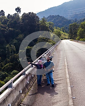 Asian couple on road for travel adventure, freedom and enjoying weekend together. Love, travelling and man and woman near