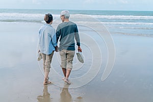 Asian couple senior elder retire resting relax walking running at sunset beach