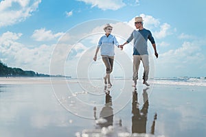 Asian couple senior elder retire resting relax walking running at sunset beach honeymoon