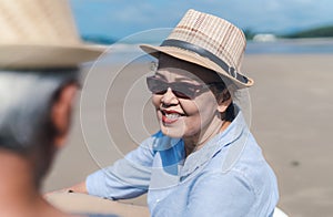 Asian couple senior elder retirement resting at beach honeymoon
