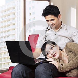 Asian couple surfing internet at home 1