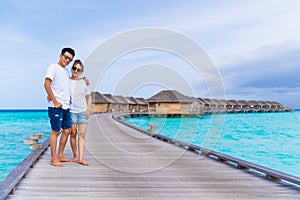 Asian couple sweetheart honeymoon traveling sea background.