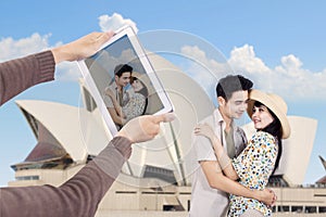Asian couple take picture at Sydney Opera House