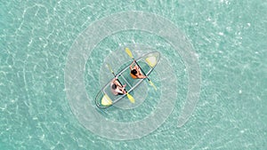 Asian couple travel Pataya by use kayak boat togather on on clean sea water