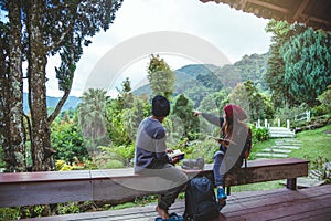 Asian couple travel photograph nature education. nature relax and study read a book. at public park. In Thailand