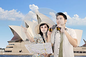 Asian couple using binoculars in Sydney, Australia