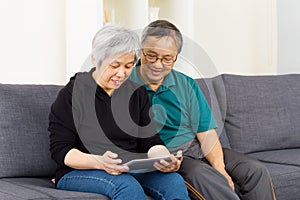 Asian couple using tablet together