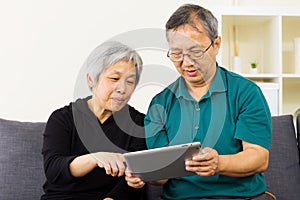 Asian couple using tablet together